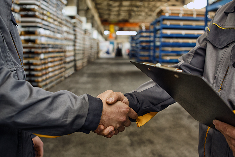 two people shaking hands in warehouse